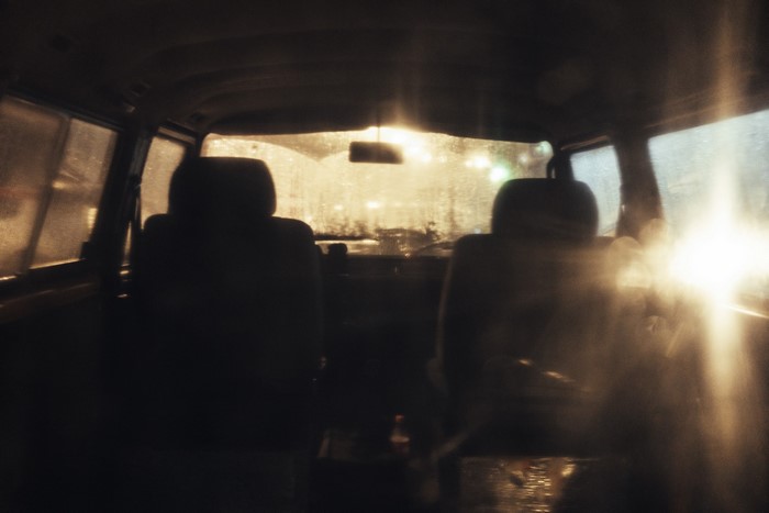 Interior of a retro car at night with street lights