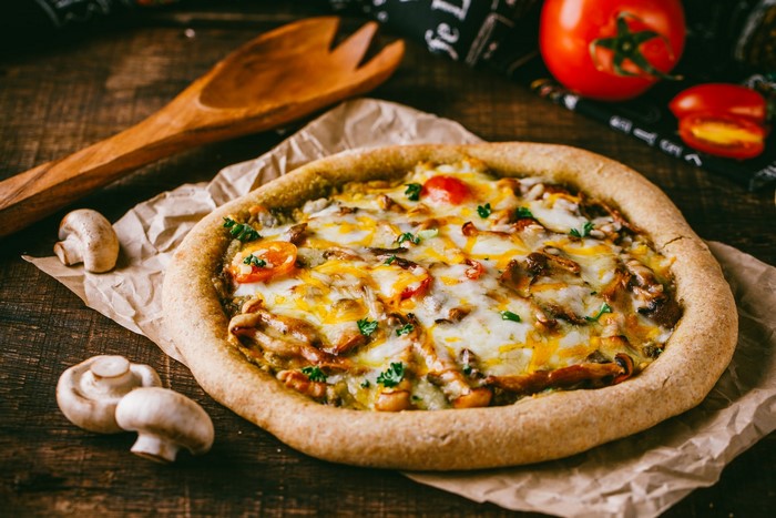 Mushroom and tomato pizza with melted cheese