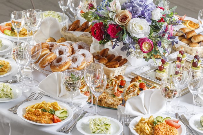 Table setting with food, drinks, and flowers
