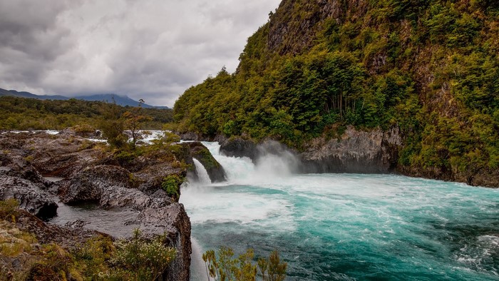 Waterfall flowing over rocks in a forest landscape