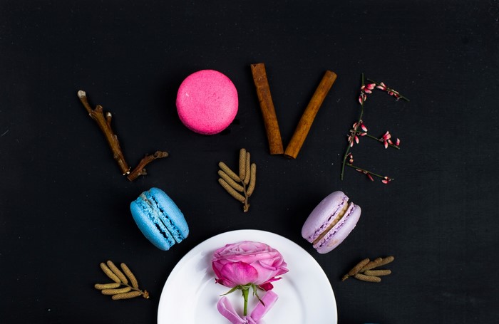 Love spelled with macarons, cinnamon, and flowers