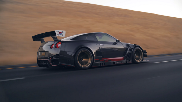 Nissan GT-R Nismo with South Korean flag on a road