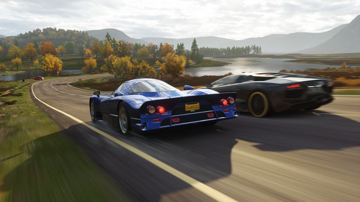 Two sports cars racing on a road in Forza Horizon 4
