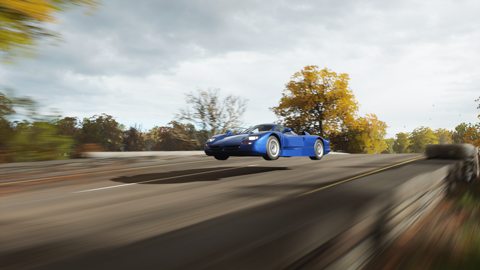 Blue sports car jumping over a road in Forza Horizon 4