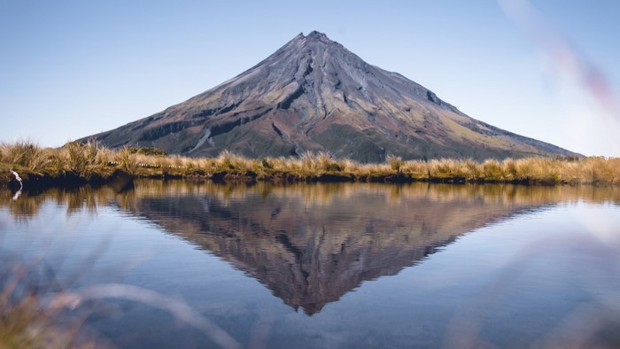Mount Taranaki reflected in a calm lake, New Zealand