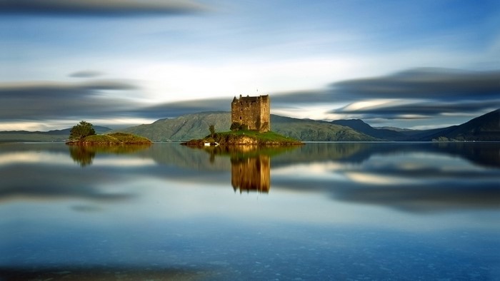 Castle on an island in a lake with reflection