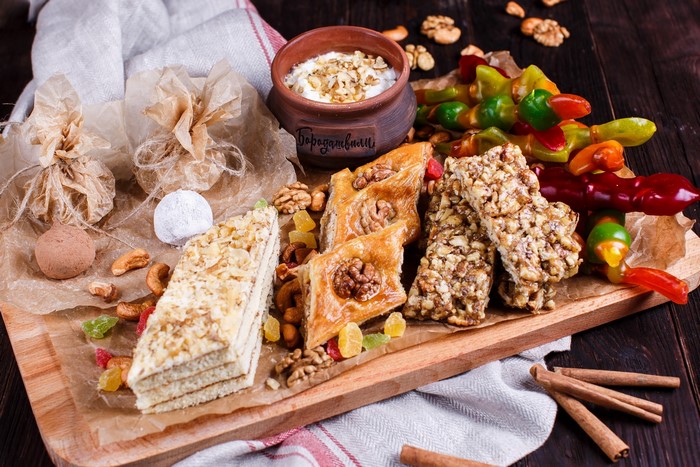 Assortment of sweets and nuts on a wooden board