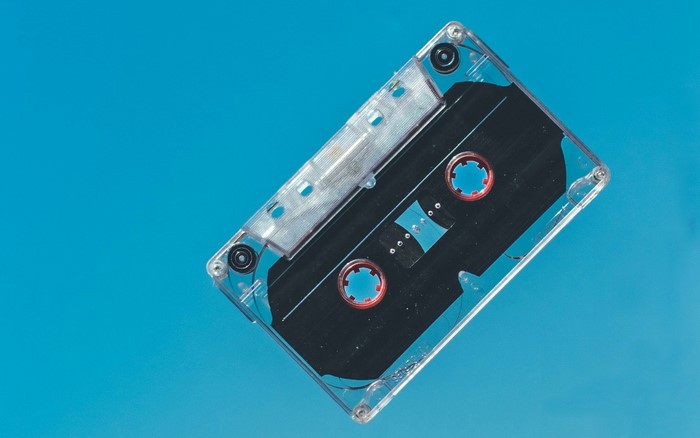 Clear cassette tape on a blue background