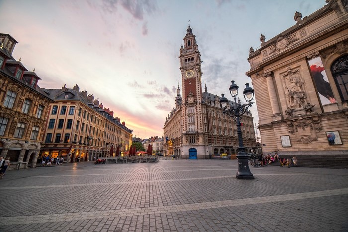 Cityscape of Lille, France at sunset with a clock tower