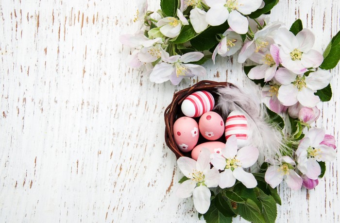 Easter eggs in a basket with flowers
