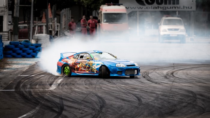 Blue Toyota Supra MK4 Drifting with Anime Graphics