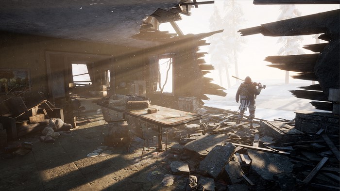 Scavengers in a ruined building with snow outside