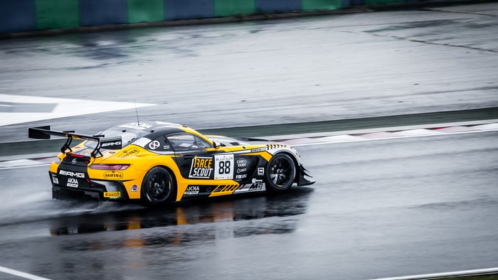 Mercedes AMG GTs racing on a wet track