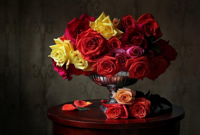 Colorful roses in a silver vase on a table