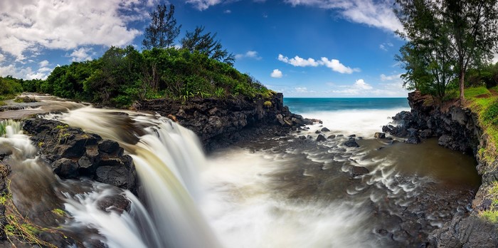 Waterfall flowing into the ocean on Reunion Island