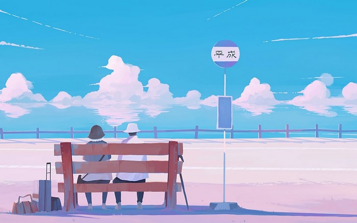 Two people sitting on a bench at a bus stop