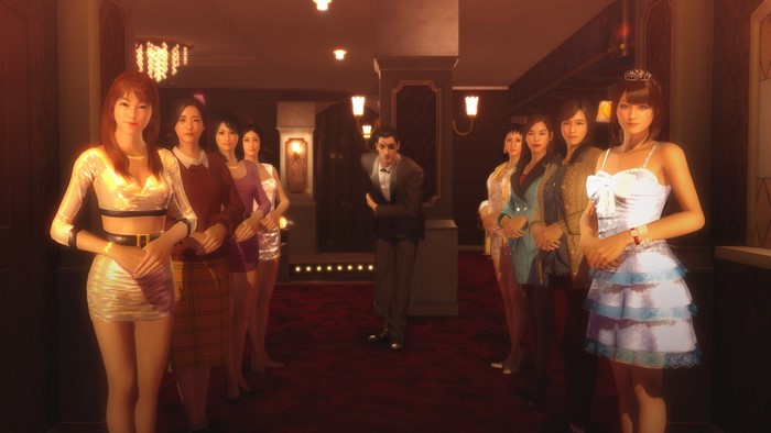 Women in dresses and a man in a suit in a cabaret