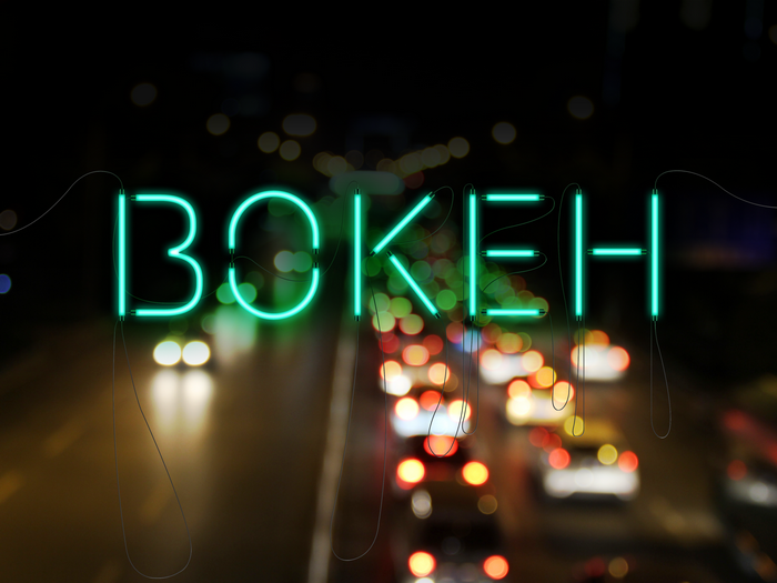 Neon sign BOKEH over a busy road at night