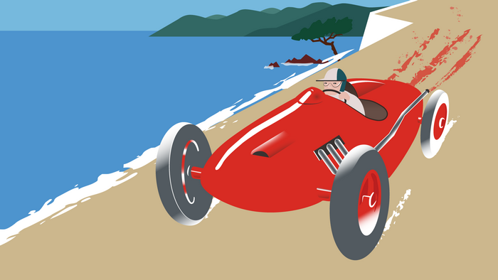 Red vintage race car driving on a beach road