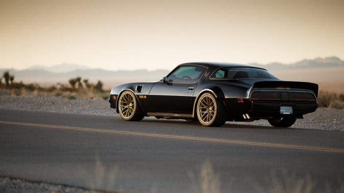 Black Pontiac Trans Am on a Desert Road