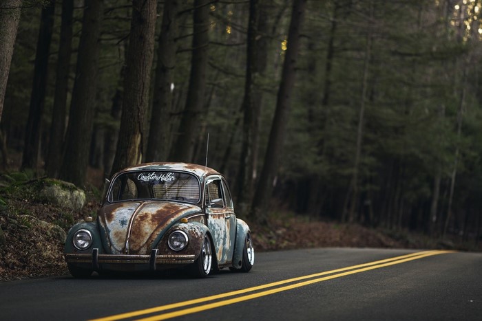 Rusty Volkswagen Beetle on a forest road