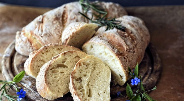 Sliced bread with rosemary and blue flowers