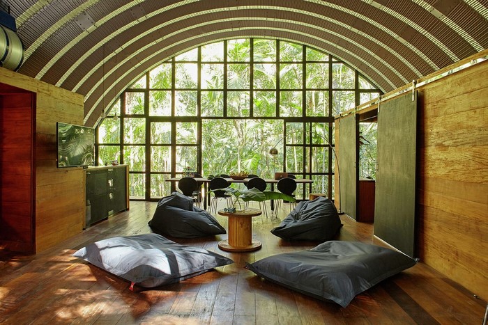 Modern living room with large arched window and beanbag chairs