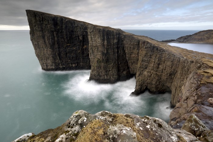 Cliff face in the Faroe Islands with waves crashing