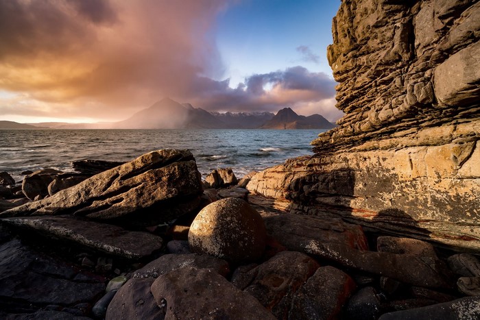 Rocky Shoreline with Mountains in the Distance
