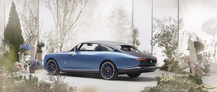 Blue Rolls-Royce Boat Tail luxury car in garden setting