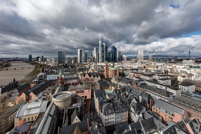 Frankfurt cityscape with modern skyscrapers and old town under cloudy sky