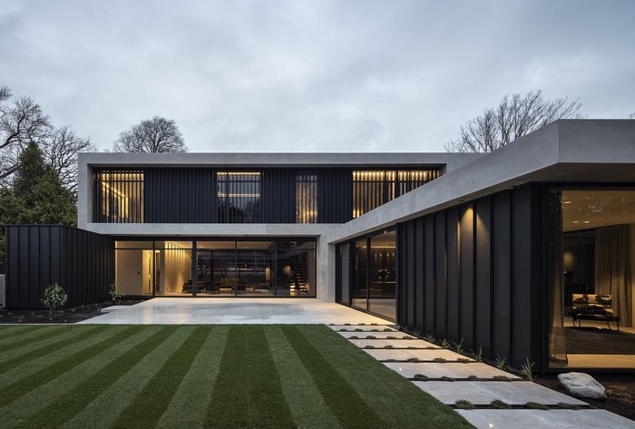 Modern concrete and black metal house with lawn