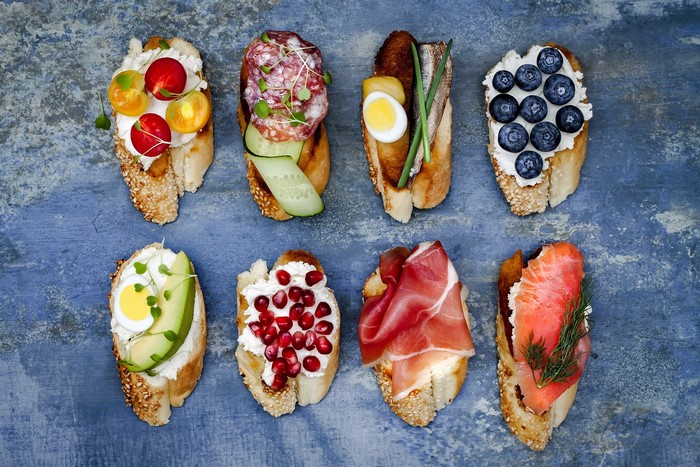 Assortment of open-faced sandwiches with various toppings