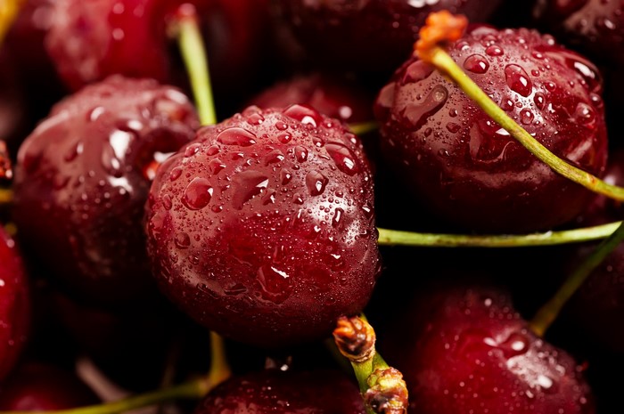 Close-up of wet cherries with water droplets