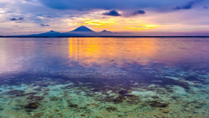 Sunset over mountains and ocean in Indonesia
