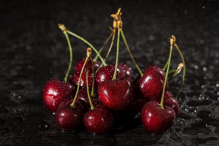 Cherries with water drops on a dark background
