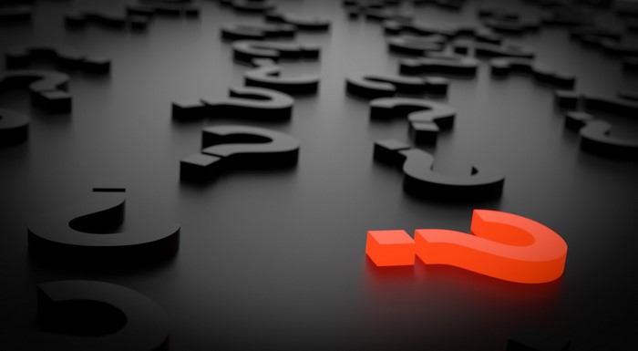 Red question mark among black question marks