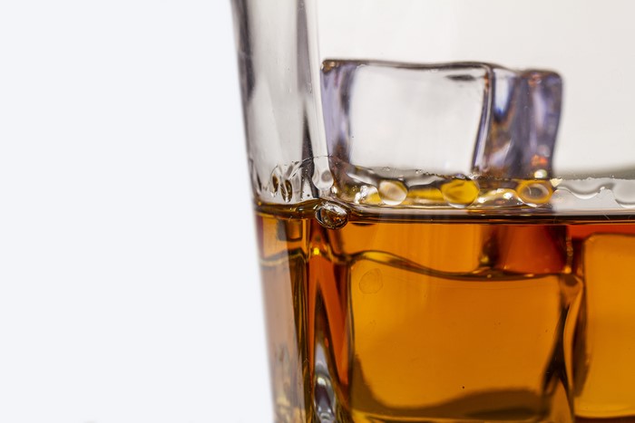 Whiskey with ice cubes in a glass