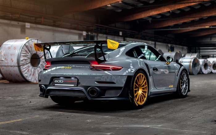 Grey Porsche 911 GT2 RS with gold wheels