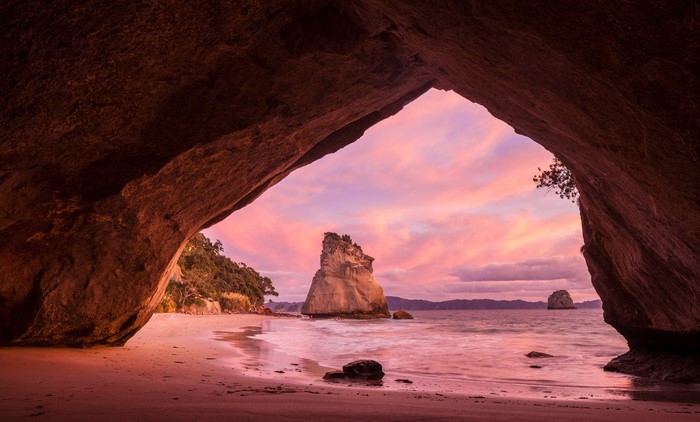 Cave entrance overlooking Cathedral Cove at sunset, New Zealand