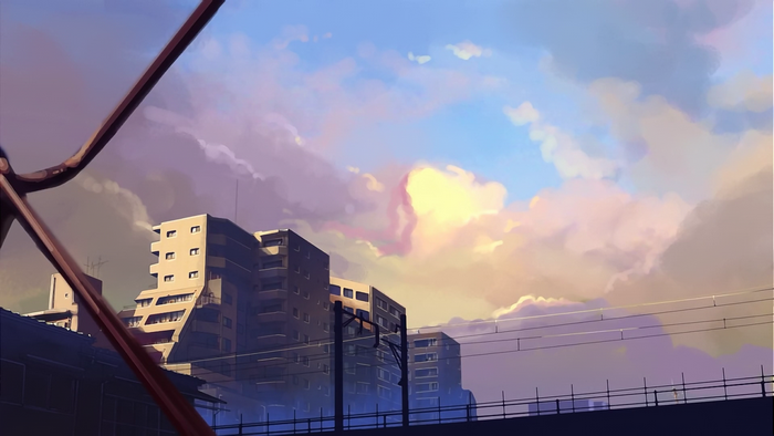 Apartment buildings and train tracks at sunset
