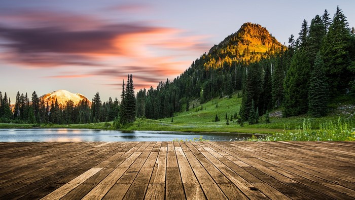 Wooden deck overlooking a lake with Mount Rainier at sunset