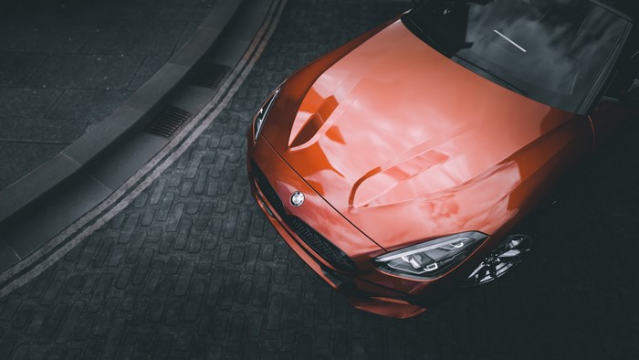 Orange BMW Z4 on a cobblestone street