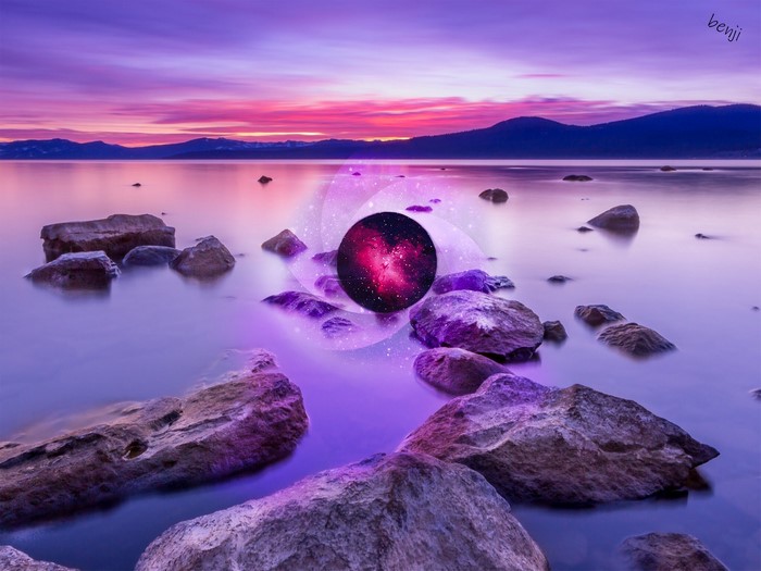 Galaxy sphere over a rocky lake at sunset