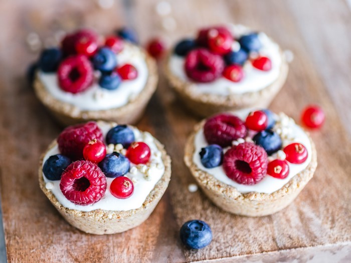 Four Berry Tarts with Cream and Berries