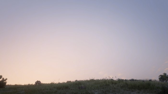 Red Dead Redemption 2 screenshot of a horse on a grassy hill