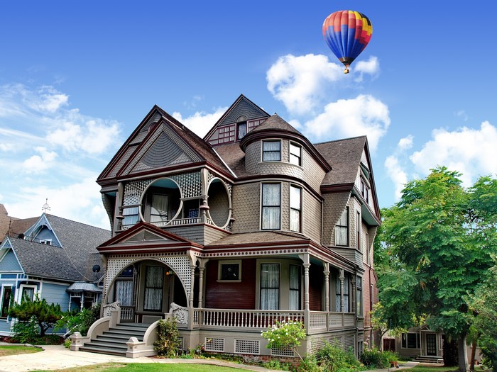 Victorian house with hot air balloon in sky