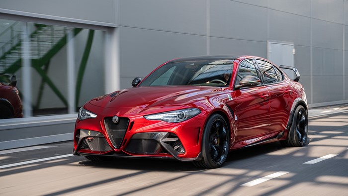 Red Alfa Romeo Giulia Quadrifoglio driving on road