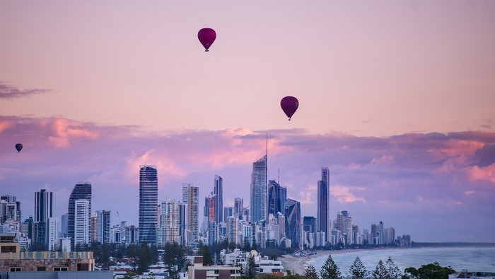 Hot air balloons over Gold Coast skyline at sunrise