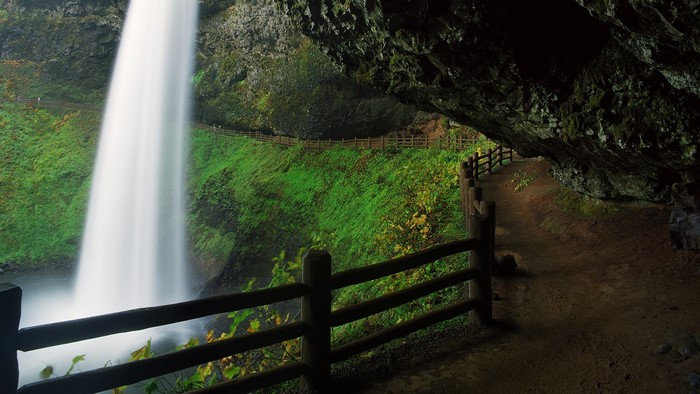 South Falls waterfall trail in Oregon with wooden fence